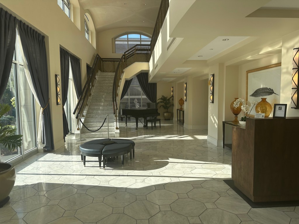 Interior of Hotel Blackhawk in Davenport, Iowa, with its marble staircase illuminated by morning sunlight.
