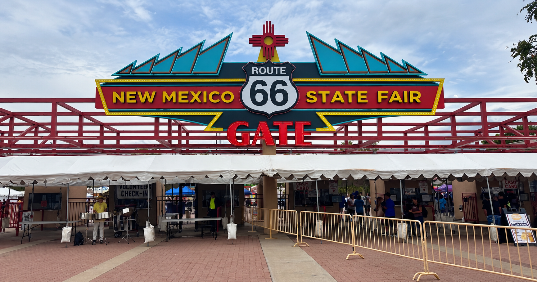New Mexico State Fair entrance with a Route 66 sign beneath a cloudy sky.