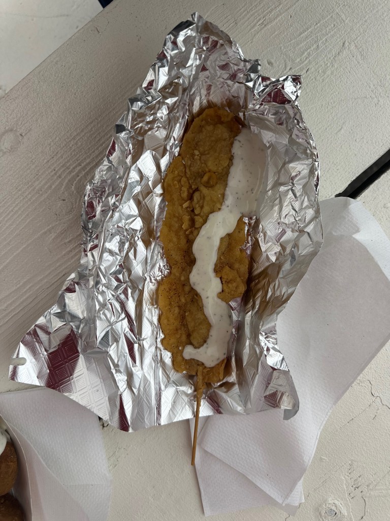 Alligator on a stick topped with Ranch and served in foil.
